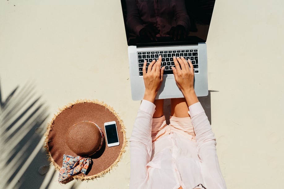 Woman Using Laptop on the Beach